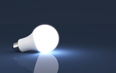 Glowing light bulb on a dark background. 