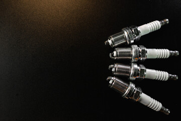 New Spark plugs on black background . car and motorcycle part. The concept of car service, repair....