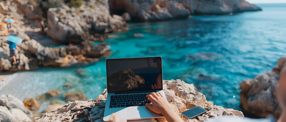 Cropped view of freelancer working on laptop on seashore