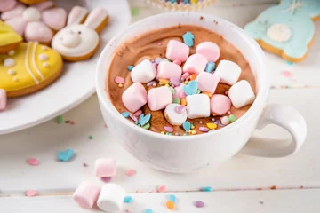 Foto op Plexiglas Hot sweet drinks for Easter party, breakfast, lunch. Easter menu. Pink, yellow, blue, brown multicolored hot chocolate cups with marshmallows, chocolate drawing rabbit, Easter eggs on latte surface © ricka_kinamoto
