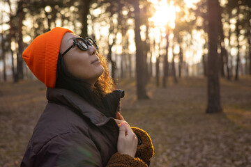 happy Asian girl enjoying life and freedom in autumn in nature