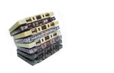 Stack of old vintage cassettes isolated on white background