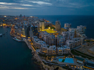 Drone aerial evening view of apartment building in Sliema, Malta