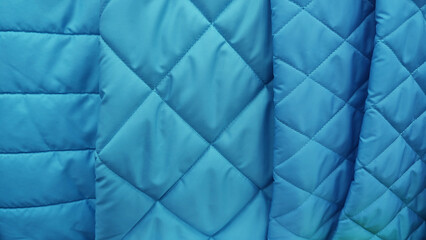 Sample of quilted textile blue color close up texture