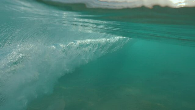 Ocean wave half half dome underwater shot in slow motion