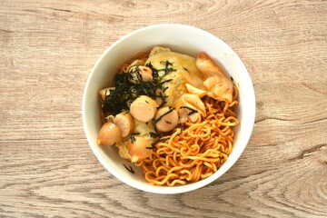 fried yakisoba Japanese noodles and cabbage topping egg and sausage dressing seaweed in sauce on bowl 