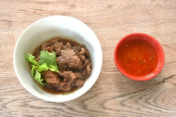braised beef meat stew topping slice celery on bowl dipping chili sauce 