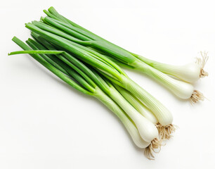 Top view of group of green scallions with shadows on white background