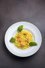 Risotto with shrimps and basil on a white plate