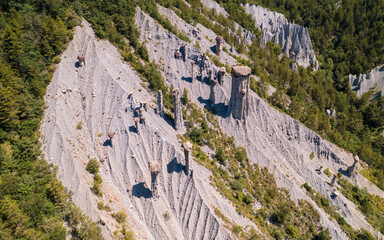Aerial photography by drone of the rock formations, the Demoiselles Coiff&eacute;es in Serre-Pon&ccedil;on and its mountains, located in the Hautes-Alpes in France