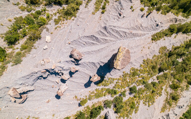 Aerial photography by drone of the rock formations, the Demoiselles Coiffées in Serre-Ponçon and its mountains, located in the Hautes-Alpes in France