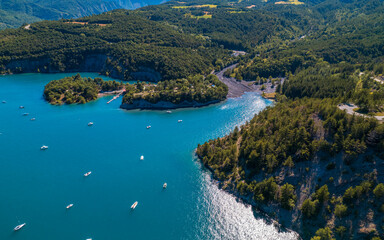 Obraz premium Aerial photography by drone of the Serre-Ponçon lake and its mountains, located in the Hautes-Alpes in France