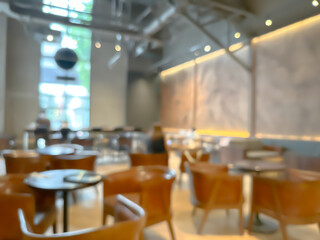 A blurred image of a modern coffee shop, elegantly decorated and warm, with customers happily working