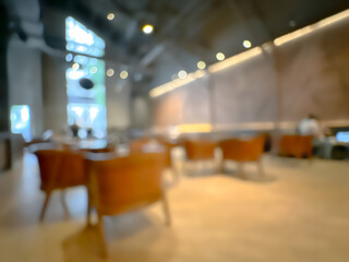 A blurred image of a modern coffee shop, elegantly decorated and warm, with customers happily working