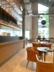 A blurred image of a modern coffee shop, elegantly decorated and warm, with customers happily working