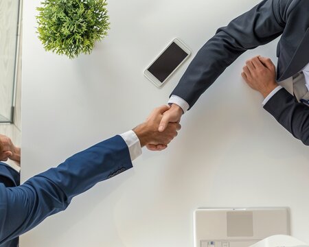 Overhead view of businessmen shaking hands.