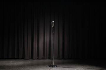 Retro microphone on a black background with light and lens flare.