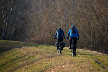 Fototapeta premium Cyclists on a mountain trail in the spring forest. Active lifestyle.