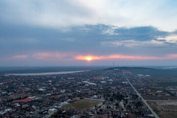 Urban Twilight Symphony: Aerial View of Cloudy Sunset Over Romanian City