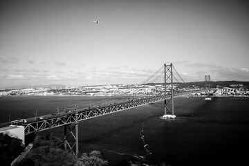 black and white picture of the suspension bridge ponte de 25 abril in lisbon