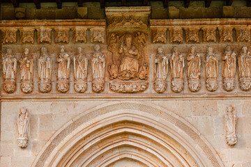 Gothic sculptural frieze, Christ in majesty surrounded by the Tetramorphs and flanked by the twelve apostles,, Pisón de Castrejón, Palencia, Spain - obrazy, fototapety, plakaty