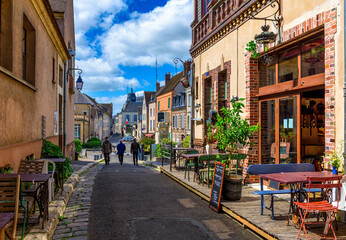 Old street with old houses and tables of cafe in a small town Chartres, France - 745825327