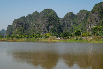 Fototapeta na wymiar Landscape Orientation of Green Mountain views of Tam Coc in the Ninh Binh Region of Vietnam