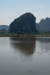 Portrait Orientation of Green Mountain views of Tam Coc in the Ninh Binh Region of Vietnam