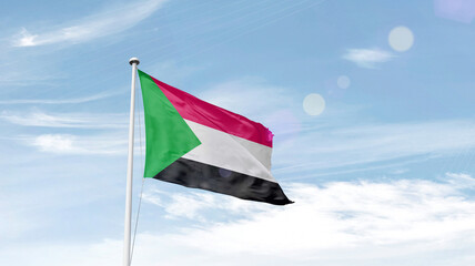 Sudan national flag cloth fabric waving on the sky.
