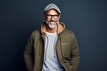 Portrait of a handsome mature man wearing warm clothes and glasses.