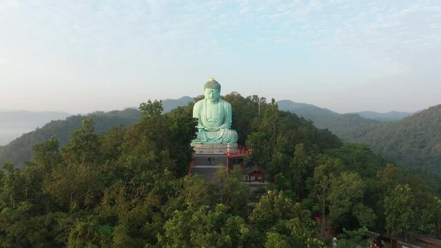 Aerial view of The Great Buddha at Doi Phra Chan is a towering bronze Buddha statue that can be reached by climbing 628 steps up at wat Prathat Doi Prachan, Pa Tan, Mae Tha District, Lampang, Thailand