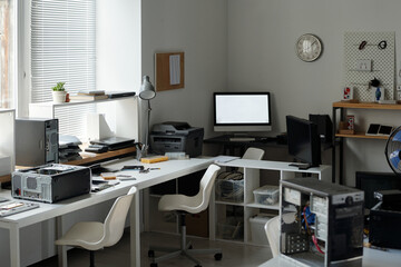 Workplace of professional technician in spacious modern repair service office with two chairs...