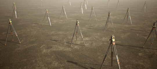 A collection of land surveyors on tripod standing on wide open flat landscape. - 745846550