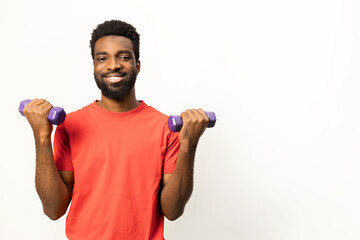Portrait of a cheerful African American man lifting weights, promoting fitness and a healthy lifestyle. Ideal image for wellness and sports-related themes. - 745847575