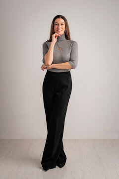 Full length of a brunette haired woman wearing business casual against isolated background