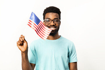 Portrait of l African American man proudly holding the American flag, representing patriotism isolated on a white background. Symbolizing joy, pride and diversity. - 745848919