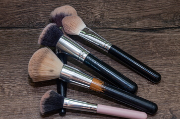 Makeup brushes lie on the table