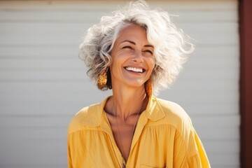 Fototapeta na wymiar Closeup portrait of a happy senior woman smiling outdoors, with copy space