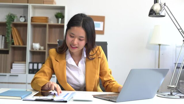 lifestyle of office workers Woman calculating expenses and using laptop. Home office. Work place. Lifestyle.