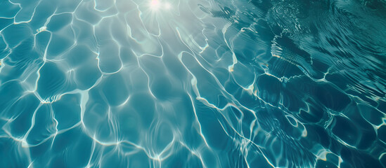 Clear blue water background with sunlight reflecting off its surface. Gentle ripples, intricate...