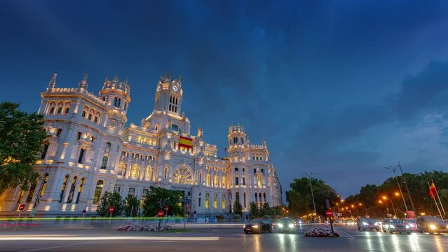 MADRID, SPAIN - FEBRUARY 19, 2024: Timelapse hyperlapse view of Cibeles palace and square, famous touristic landmark. Fountain on the square and traffic circle around.