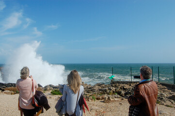 Fototapeta premium family on the beach waves breaking in the coast