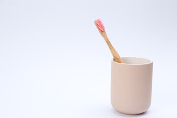 Bamboo toothbrush in holder isolated on white