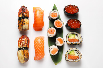 Different tasty sushi rolls on white background, flat lay