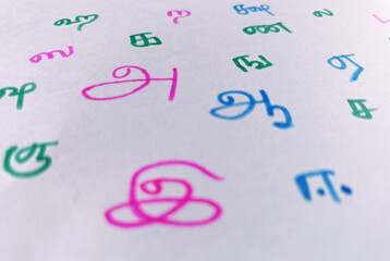 Hand written Colorful sketched Random Tamil language letters in sheet. in translation A, Aa, E....