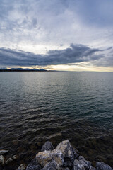 Sunset time over the lake with thick cloud hiding the sun