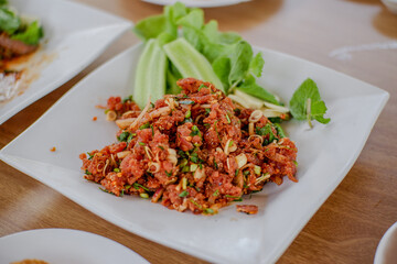 Raw meat beef cook, Spicy minced beef salad slice mixed with spices and herbs vegetable food of northeast Thailand style local.