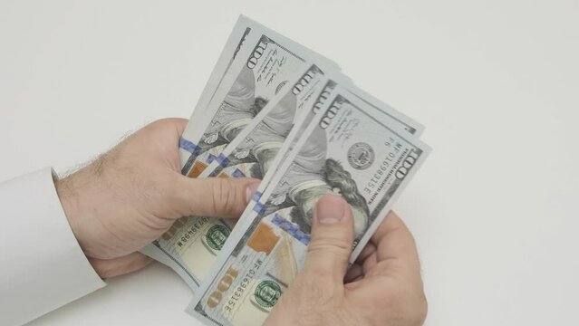 male hands counting stack of hundred-dollar US banknotes cash
