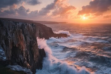 Coastal cliffs with crashing waves below and a dramatic sunset nature landscape