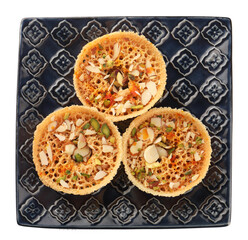 Rajasthani Ghevar. Ghewar is an Indian crunchy sweet dish made using refined flour, sugar, and ghee. Garnished with silver foil and dry fruits.